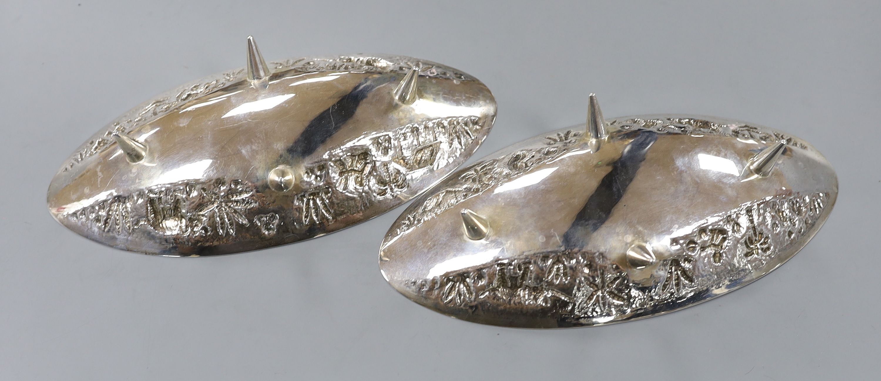 A pair of Indian sterling oval dishes, embossed with figures and elephants, 24.9cm, 18.5oz.